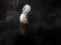 A masked Palestinian youth stands amidst smoke during clashes with Israeli security forces on November 26, 2019 near the West Bank city of Nablus as Palestinians stage a "day of rage" against a recent US decision to no longer consider settlements in the West Bank illegal. The US broke with decades of international consensus on November 18 as its secretary of state announced the country would no longer consider Israeli settlements in the occupied Palestinian territories illegal. Israel, led by its prime mini