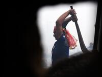 A Hindu devotee slaughters a buffalos as a offering during the Gadhimai Festival in Bariyarpur on December 3, 2019. Thousands of Hindu devotees gathered in southern Nepal for a festival believed to be the world's biggest ritual animal slaughter, despite court orders and calls by animal activists to end the event. The sacrifices take place every five years in Bariyarpur village close to the Indian border, in honour of the Hindu goddess of power. Prakash MATHEMA / AFP