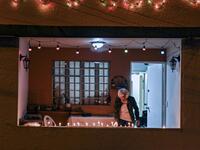 A woman lights a candle at the Comuna 13 in Medellin, Colombia, on December 7, 2019, on the Day of the Little Candles. The Day of the Little Candles is a traditional Colombian celebration which commemorates the Immaculate Conception of the Virgin Mary and marks the beginning of the Christmas season. On this day, light candles in their homes, on streets, and at cemeteries to decorate the graves of their dead. JOAQUIN SARMIENTO / AFP