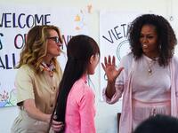 Former US First Lady Michelle Obama (R) and actress Julia Roberts (L) meet Vietnamese students in Can Giuoc district, Long An province on December 9, 2019. Michelle Obama and Julia Roberts visit to promote girls' education in Vietnam. Nhac NGUYEN / AFP