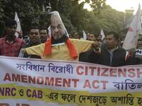 Indian left wing activists of Democratic Youth Federation of India (DYFI) shout slogans as they burn an effigy of India's Home Minister Amit Shah during a demonstration against the Indian government's Citizenship Amendment Bill in Siliguri on December 14, 2019. SILIGURI, INDIA