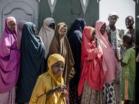 A group of displaced women, due to intense flooding, queue at the entrance of a distribution center waiting for sanitary pads at a displacement camp in Beledweyne, Somalia, on December 14, 2019. The rains have inundated big areas surrounding Beledweyne area forcing thousands of people to leave their houses and look for humanitarian assistance while living in displacement camps. Due to climate change and human activities, cycles of floods and droughts have become more recurrent and completely unpredictable i