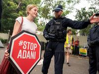 Police disperse demonstrators during a climate protest in Sydney on December 19, 2019. Protesters marched on Australian Prime Minister Scott Morrison's official residence in Sydney to demand curbs on greenhouse gas emissions and highlight his absence on an overseas holiday as bushfires burned across the region. Wendell TEODORO / AFP
