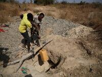 Miners work at a mining site in Anka near Gusau, on December 4,2019. For generations, the mineral-rich earth of Nigeria's Zamfara state has provided families living here with a way to make ends meet. But in recent years their trade has become increasingly unsafe. The mines lie within the reach of heavily-armed groups -- dubbed "bandits" by the local authorities -- that have been terrorising this remote region.  Kola Sulaimon / AFP
