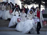 Couples arrive for a "mass ice and snow wedding" ahead of the opening of the Harbin International Ice and Snow Festival in Harbin, in China's northeast Heilongjiang province on January 5, 2020. Noel CELIS / AFP