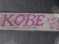 A note is written on the pavement as fans mourn the death of NBA legend Kobe Bryant, who was killed along with his daughter and seven others in a helicopter crash on January 26, at LA Live plaza in front of Staples Center in Los Angeles on January 27, 2020. Federal investigators sifted through the wreckage of the helicopter crash that killed basketball legend Kobe Bryant and eight other people, hoping to find clues to what caused the accident that stunned the world. Robyn Beck / AFP