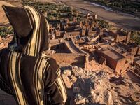 A man stands overlooking the Kasbah (ancient fortress) of Ait-Ben-Haddou, where scenes depicting the fictional city of Yunkai from the hit HBO television series "Game of Thrones" were filmed, about 32 kilometres northwest of the city of Ouarzazate south of Morocco's High Atlas mountains on January 27, 2020.FADEL SENNA / AFP