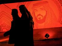 A picture taken on January 31, 2020 shows young Saudis walking next to a portrait of Crown Prince Mohammed bin Salman at the Riyadh Season Boulevard in the Saudi capital. In Saudi Arabia's rigid past, religious police once swooped down on rose sellers and anyone peddling red paraphernalia around Valentine's Day, but now a more open -- albeit risky -- dating culture is taking root. Pursuing relationships outside of marriage in the conservative Islamic kingdom once amounted to a death wish, and would-be Romeo