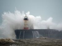 Waves crash over Newhaven Lighthouse on the south coast of England on February 9, 2020, as Storm Ciara swept over the country. GLYN KIRK / AFP