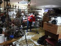 A woman sweeps water from the floor during the clean-up efforts at a business in Hebden Bridge, northern England, on February 10, 2020 after the flooding brought by Storm Ciara. Storm Ciara grounded hundreds of flights Monday and left swatches of Europe without power after unleashing torrential rain and causing flash flooding that cancelled football matches in Britain. Oli SCARFF / AFP