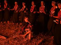 This photo taken on February 6, 2020 shows Naga tribeswomen taking part in an overnight ceremony to bless the harvest in Satpalaw Shaung village, Lahe township in Myanmar's Sagaing region. A haunting refrain pierces the night as the tribeswomen of the Gongwang Bonyo, among the most isolated people in Myanmar, dance around a campfire to bless the harvest ahead. Ye Aung THU / AFP