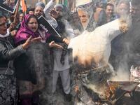  Congress party supporters in Amritsar burn an effigy of Narendra Modi during a demonstration to protest against the violence occurring in Delhi. Photograph: Narinder Nanu/AFP via Getty Images