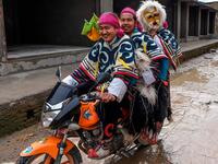 Tibetan in exile performers arrive on a motorbike before performing at the Boudhanath Stupa area during celebrations marking the third day of the Lhosar Tibetan New Year in Kathmandu (Twitter)
