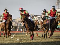 In this photograph taken on January 7, 2020, Linthoingambi Kangjei Lup Polo Club player Khundongbam Dementy (C) shoots to score during their 15th Women's State Polo Tournament match against Chingkheihunba Polo Club at the Mapal Kangjeibung (Polo Ground) in Imphal, the capital of the northeastern Indian state of Manipur. Laishram Thadoi's face is a picture of concentration as she adjusts her helmet and prepares to play in Manipur, the remote Indian state regarded as the birthplace of modern polo. Xavier GALI