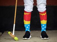 In this photograph taken on January 9, 2020, Linthoingambi Kangjei Lup Polo Club player Khundongbam Dementy, wearing a pair of 'Wonder Woman' socks, follows a match from the sidelines at the Mapal Kangjeibung (Polo Ground) in Imphal, the capital of the northeastern Indian state of Manipur. Laishram Thadoi's face is a picture of concentration as she adjusts her helmet and prepares to play in Manipur, the remote Indian state regarded as the birthplace of modern polo. Xavier GALIANA / AFP