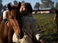 In this photograph taken on January 11, 2020, polo player Shanglenmayum Sangeeta ties a rope on a Manipuri pony on a field in Imphal, the capital of the northeastern Indian state of Manipur. Laishram Thadoi's face is a picture of concentration as she adjusts her helmet and prepares to play in Manipur, the remote Indian state regarded as the birthplace of modern polo. Xavier GALIANA / AFP