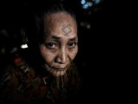This photo taken on February 6, 2020 shows Khamyo Pon Nyun, 75, a tattooed Lainong tribeswoman resting at her house at Lahel township in Sagaing region of Myanmar, wedged in a semi-autonomous zone near the Indian border. People in the region subscribe to a complex patchwork of customs, intertwining their animist beliefs with warrior traditions that include striking tattoo designs, which can signify tribal identity, life accomplishments or the completion of a rite of passage. Ye Aung THU / AFP