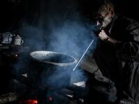 This photo taken on February 9, 2020 shows Nok Tan, 75, a tattooed Konyak tribeman, cooking in his house in a village in Sagaing region of Myanmar, wedged in a semi-autonomous zone near the Indian border. People in the region subscribe to a complex patchwork of customs, intertwining their animist beliefs with warrior traditions that include striking tattoo designs, which can signify tribal identity, life accomplishments or the completion of a rite of passage. Ye Aung THU / AFP