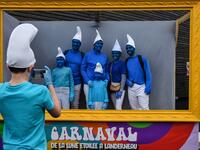 People dressed as Smurfs ('Schtroumpfs' in French), a Belgian comic franchise centered on a fictional colony of small, blue, human-like creatures who live in mushroom-shaped houses in the forest, pose for a picture during a world record gathering of Smurfs on March 7, 2020, in Landerneau, western France. Damien MEYER / AFP