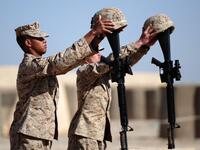 In this file photo taken on January 30, 2010, US Marines from 1st Battalion, 6th regiment, Charlie company prepare memorials for Sergeant Daniel Angus and Lance Corporal Zachary Smith, who were killed on the battlefield on January 24, in Fiddler's Green camp, on the outskirts of Marjah in central Helmand. American forces have started pulling out of two bases in Afghanistan, a US official said on March 10, 2020 the day peace talks between Kabul and the Taliban were due to start despite widespread violence an