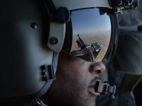 In this file photo taken on August 11, 2014, a US soldier, part of the NATO-led International Security Assistance Force (ISAF), looks out onboard a Chinook helicopter over the Gardez district of Paktia province. American forces have started pulling out of two bases in Afghanistan, a US official said on March 10, 2020 the day peace talks between Kabul and the Taliban were due to start despite widespread violence and a political crisis. The United States is keen to end its longest-ever conflict, and under the