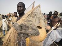 A fisherman poses with a fishing net and a calabash before attending the Argungu fishing and cultural festival at Argungu Town, Kebbi State, in northwest Nigeria, on March 14, 2020. Argungu fishing and cultural festival is one of the oldest and most widely attended festivals in the country dating back many generations, featuring series of water competitions and traditional games. The festival returned after 10 years suspension due to insecurity in northwest Nigeria. PIUS UTOMI EKPEI / AFP