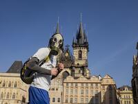 A man with a gas mask runs across the Old Town Square on March 18, 2020, in Prague, where activities came to a halt due to the spread of the novel coronavirus. The Czech Republic, a European Union country of 10.7 million people, has registered 464 confirmed cases of the virus, including three cured patients, and no deaths. Michal Cizek / AFP