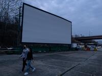 But at drive-in cinemas, moviegoers can enjoy a movie from the comfort of their cars, parked in front of a large outdoor screen.  Ed JONES / AFP