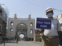 A traffic police personnel holds a placard on a deserted road during a one-day nationwide Janata (civil) curfew imposed as a preventive measure against the COVID-19 coronavirus, in Hyderabad on March 22, 2020. Nearly one billion people around the world were confined to their homes, as the coronavirus death toll crossed 13,000 and factories were shut in worst-hit Italy after another single-day fatalities record. NOAH SEELAM / AFP