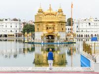 A Sikh devotee pays respect at the deserted Golden Temple during the first day of a 21-day government-imposed nationwide lockdown as a preventive measure against the COVID-19 coronavirus, in Amritsar on March 25, 2020. NARINDER NANU / AFP