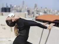 Sherazade Mami, a 28-year-old Tunisian professional dancer and performer at the Caracalla dance theatre and a teacher at the Caracalla dance school, practices while wearing a surgical mask on the roof of her apartment building in the suburb of Dekwaneh on the eastern outskirts of Lebanon's capital Beirut on April 4, 2020. Due to the confinement regulations imposed to combat the COVID-19 coronavirus pandemic, Mami opted to continue practicing on her rooftop to remain in shape. JOSEPH EID / AFP
