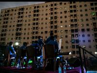 A music band formed by Sri Lankan Navy personnel plays outside a housing complex during a government-imposed nationwide lockdown as a preventive measure against the COVID-19 coronavirus, in Colombo on April 9, 2020. ISHARA S. KODIKARA / AFP