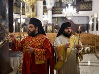 Deacons swing incense censers during the Easter Vigil at the Greek Orthodox Church of Saint Savvas in the old walled city of the Cypriot capital Nicosia on April 18, 2020, as prayers are held without a congregation due to the COVID-19 coronavirus pandemic. Amir Makar / AFP