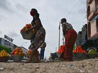 Street vendors sell fruits in a street in Abidjan on April 24, 2020 on the first day of Islamic Holy Month of Ramadan. ISSOUF SANOGO / AFP