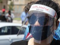 A Lebanese anti-government protester wearing protective gear amid the COVID-19 pandemic bearing the inscription "the revolution of the workers and of the free", takes part in a demonstration in downtown Beirut against the growing economic hardship, on May 1, 2020, marking International Workers' Day (Labour Day). ANWAR AMRO / AFP