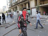 Lebanese anti-government protesters, some wearing protective masks amid the COVID-19 pandemic, block a road during a demonstration against the growing economic hardship in downtown Beirut on May 1, 2020, marking International Workers' Day (Labour Day). ANWAR AMRO / AFP