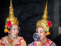 Traditional Thai dancers wearing protective face shields relax after a performance at the Erawan Shrine, which was reopened after the Thai government relaxed measures to combat the spread of the COVID-19 novel coronavirus, in Bangkok on May 4, 2020. Thailand began easing restrictions related to the COVID-19 novel coronavirus on May 3 by allowing various businesses to reopen, but warned that the stricter measures would be re-imposed should cases increase again. Mladen ANTONOV / AFP
