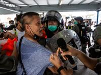 Police officers clash with a pro-democracy demonstrator (C) in the Tsim Sha Tsui waterfront during a pro-democracy protest calling for the city's independence in Hong Kong on May 10, 2020. ISAAC LAWRENCE / AFP