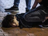 Undercover police arrest and handcuff a pro-democracy demonstrator (C) during a pro-democracy protest calling for the city's independence in Mong Kok district of Hong Kong on May 10, 2020. ISAAC LAWRENCE / AFP