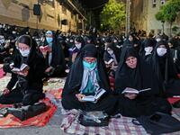 Iranians wearing face masks against the Covid-19 coronavirus attend Laylat al-Qadr prayers, one of the holiest nights during the Muslim fasting month of Ramadan, outside a mosque in the Tehran, on May 13, 2020. ATTA KENARE / AFP