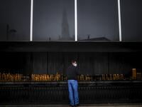 A man wearing a face mask lights a candle during the 103rd anniversary of the apparitions of Our Lady of Fatima at the Fatima shrine in central Portugal on May 13, 2020. Without the crowd of pilgrims it welcomes every year, the shrine of Fatima celebrated the anniversary during a religious ceremony reduced to the bare minimum. PATRICIA DE MELO MOREIRA / AFP