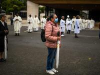 People attend a ceremony marking the 103rd anniversary of the apparitions of Our Lady of Fatima at the Fatima shrine in central Portugal, on May 13, 2020. Without the crowd of pilgrims it welcomes every year, the shrine of Fatima celebrated the anniversary during a religious ceremony reduced to the bare minimum. PATRICIA DE MELO MOREIRA / AFP