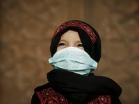 A Palestinian child clad in mask due to the COVID-19 coronavirus pandemic stands outside a mosque upon arriving for the prayers of Eid al-Fitr, the Muslim holiday which starts at the conclusion of the holy fasting month of Ramadan, in Gaza City on May 24, 2020. Local authorities in the Hamas-run Palestinian enclave allowed mosques to reopen for Eid al-Fitr as social distancing procedures for the novel coronavirus are maintained while encouraging the elderly to perform prayers from home. MOHAMMED ABED / AFP