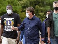 Brazil's President Jair Bolsonaro gives his thumb up upon arrival at Planalto Palace in Brasilia, on May 24, 2020, amid the COVID-19 coronavirus pandemic. Despite positive signs elsewhere, the disease continued its surge in large parts of South America, with the death toll in Brazil passing 22,000 and infections topping 347,000, the world's second-highest caseload. EVARISTO SA / AFP