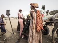 A family of Fulani herders pack their cart before making their way back to their camps after trying to buy and sell goods at a unofficial herders market in Barkedji on May 28, 2020. COVID-19 coronavirus restrictions have closed down markets and regional movement, as a result Fulani herders are struggling to move to areas with more grazing land for there live stock. Closures of markets have meant that the prices for live stock has dropped by up to fifty percent, leaving the pastoralist stuck with out being a