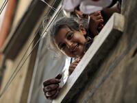 A girl peeks out of a window in the Bab al-Tabbaneh neighbourhood of Lebanon's northern city of Tripoli on June 3, 2020. Thousands of residents of Lebanon's northern Tripoli struggle to put food on the table, as the country's worst economic crisis in decades has picked up in speed in recent weeks, with food prices rising by more than 70 percent since the autumn. Inflation has been a blow in the country where more than 45 percent of the country's population now lives below the poverty line, and more than 35 