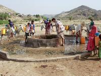 Yemenis fill their jerrycans carried by donkeys, with water from a cistern at a make-shift camp for the internally displaced, in the northern Hajjah province, on June 7, 2020, amid a severe shortage of water. ESSA AHMED / AFP