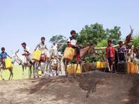 Yemeni youths, some riding donkeys, wait to fill their jerrycans with water from a cistern at a make-shift camp for the internally displaced, in the northern Hajjah province, on June 7, 2020, amid a severe shortage of water. ESSA AHMED / AFP