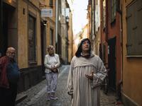 Tour guide Mike Anderson takes visitors on May 30 ,2020 on a 'plague walk', taking them around sites in Stockholm's old town related to pandemics of the plague in the 14th and 18th century, and an outbreak of cholera that hit the city in the mid-19th century. Jonathan NACKSTRAND / AFP