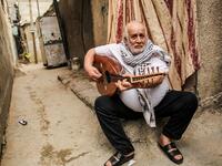Tawfiq Shanaa, a 66-year-old man, plays the oud as he performs traditional Palestinian songs outside his house in the Rafah camp for Palestinian refugees in the southern Gaza Strip on June 20, 2020. June 20 marks World Refugee Day, a day dedicated by the United Nations General Assembly to raising awareness of the situation of refugees throughout the world. SAID KHATIB / AFP